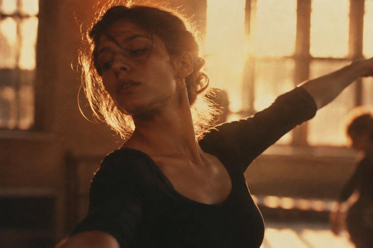 Dancer mid-motion under warm stage light